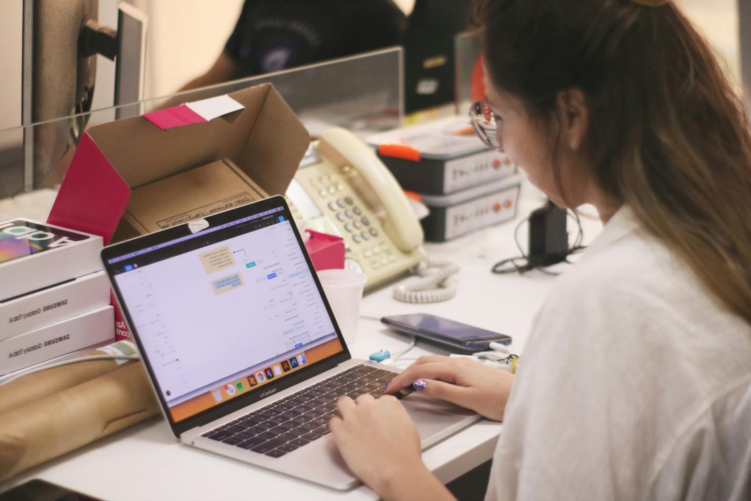 Student learning stock market analysis on computer with financial charts